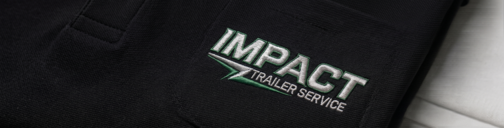 Impact Trailer Service embroidered logo on work shirt